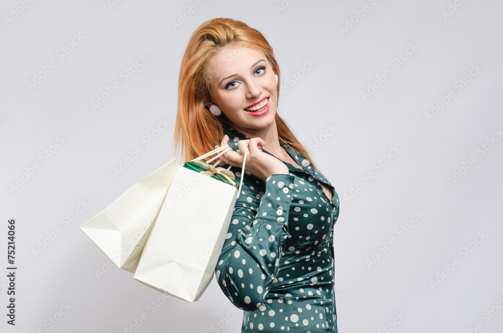 Girl with many shopping bags and gifts shopping for the holidays Girl with many shopping bags and gifts shopping for the holidays