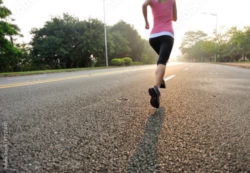 woman runner running at sunrise road 