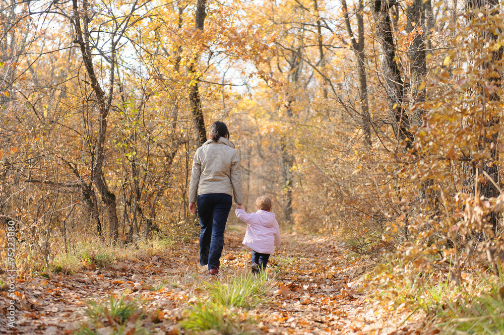 Mother and Daughter Walking in Forest