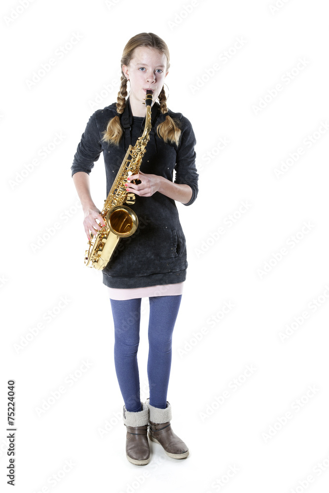 Naklejka premium teenage girl plays saxophone in studio with white background