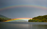 Double rainbow over a mountain lake.