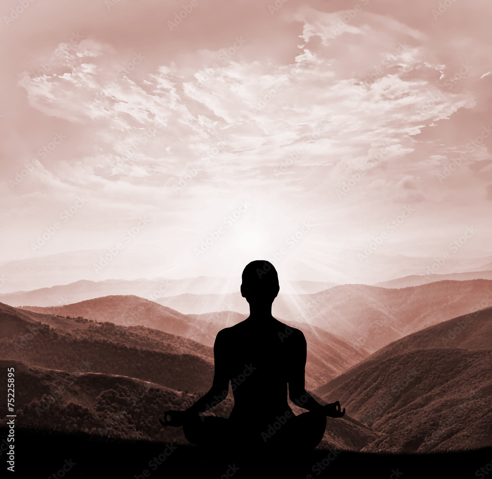 Yoga practicioner during the sunset meditation Yoga practicioner during the sunset meditation