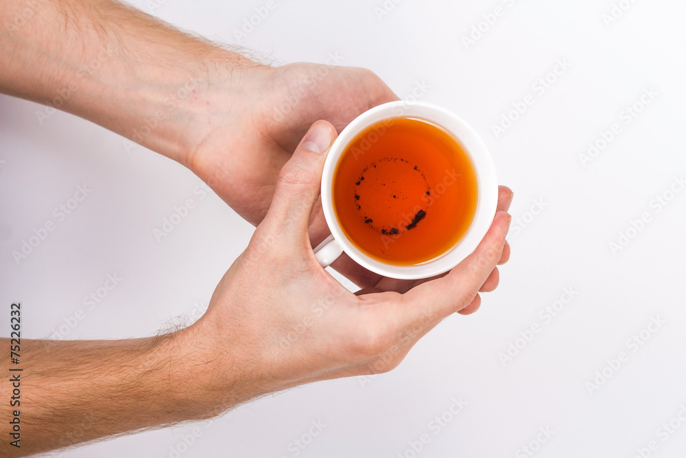 male hands holding a cup of tea male hands holding a cup of tea