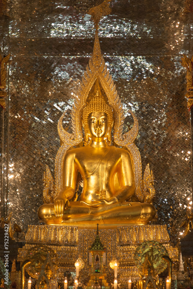 gold buddha statue in church at buddhist temple in Thailand