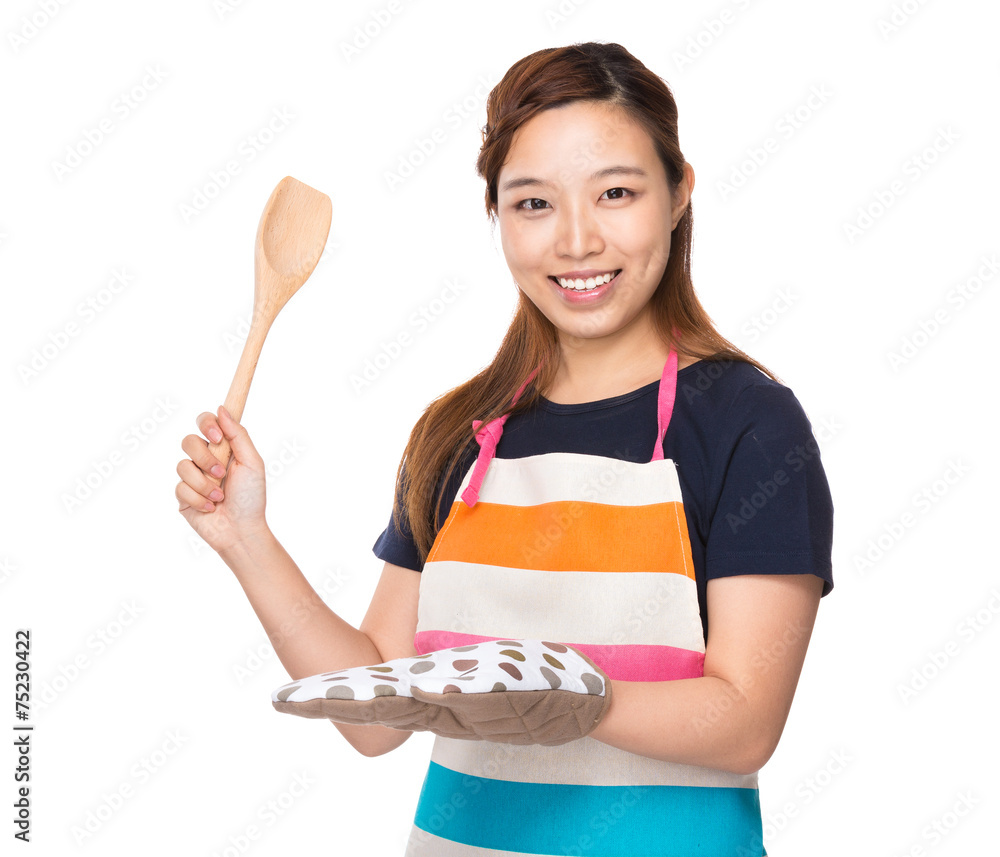 Asian Housewife hold with wooden ladle and oven gloves Asian Housewife hold with wooden ladle and oven gloves