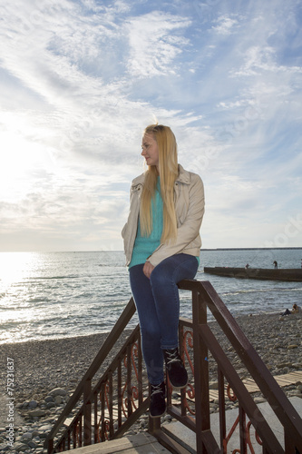 Beautiful blonde looks at the sea.