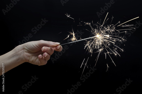 woman's hand holding a sparkler