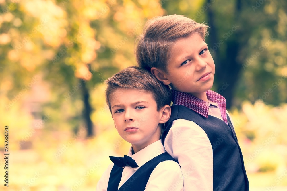 Fototapeta premium Portrait of a boy on a background of green nature