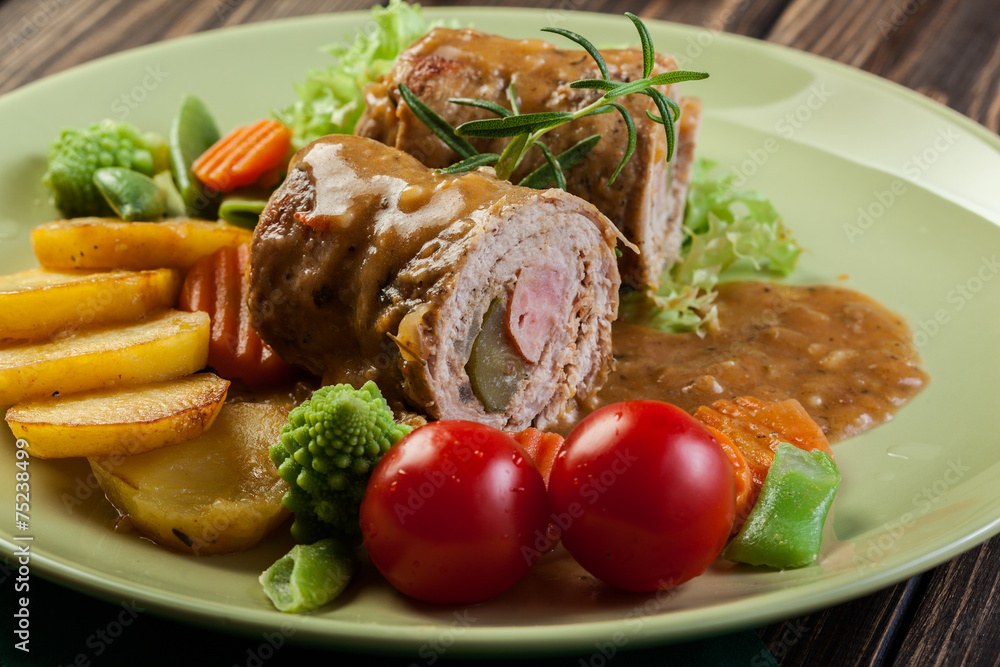 Pork rolls with prepared potatoes and vegetables Pork rolls with prepared potatoes and vegetables
