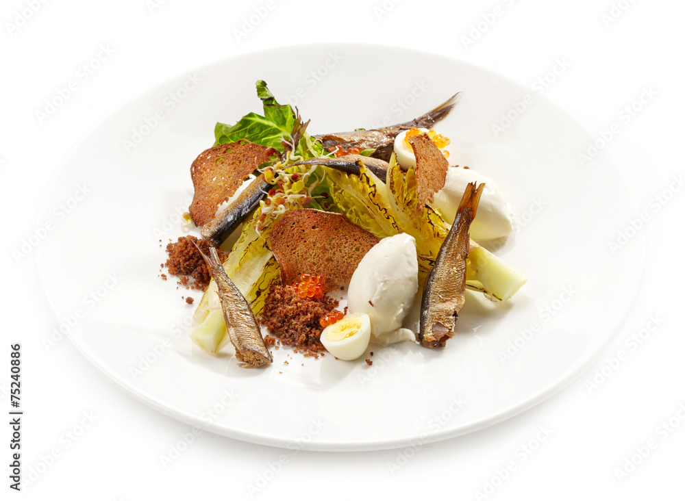 plate of salad with sprats and sour cream plate of salad with sprats and sour cream