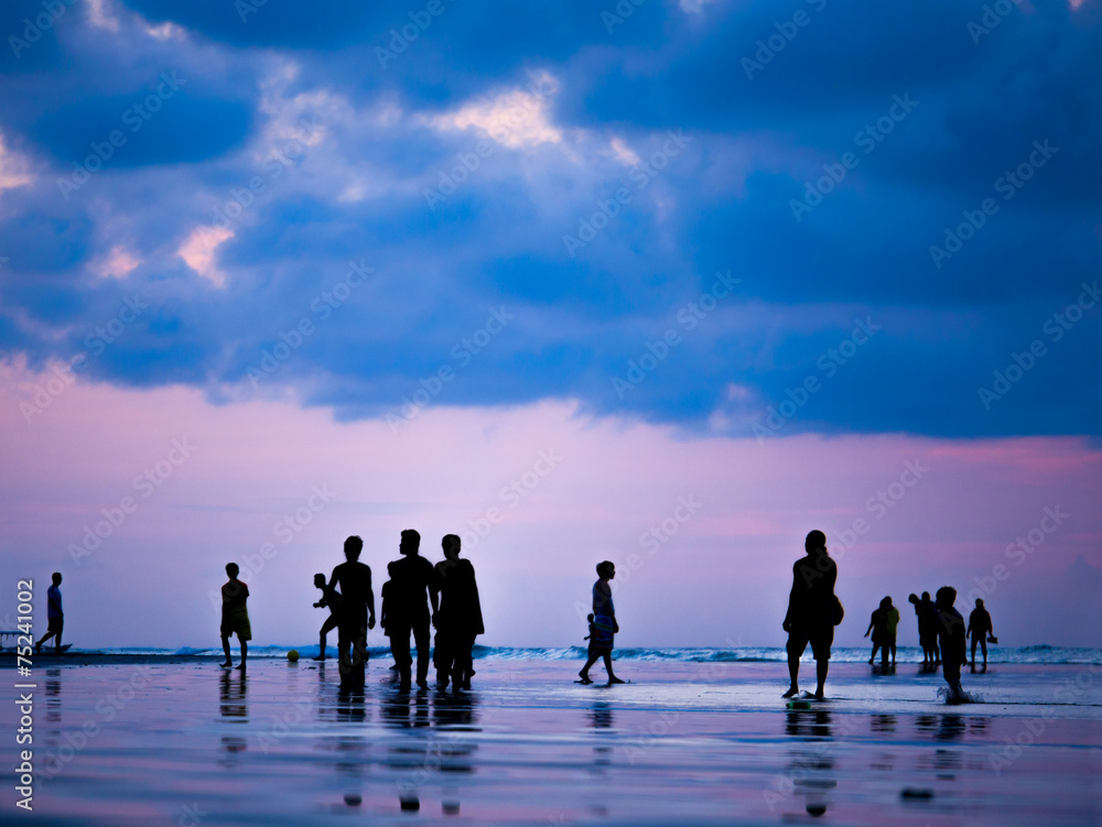 Silhouettes of people at sunset on the beach of Kuta Bali I