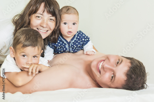 Portrait of Happy caucasian Family of Four People Together Indoo