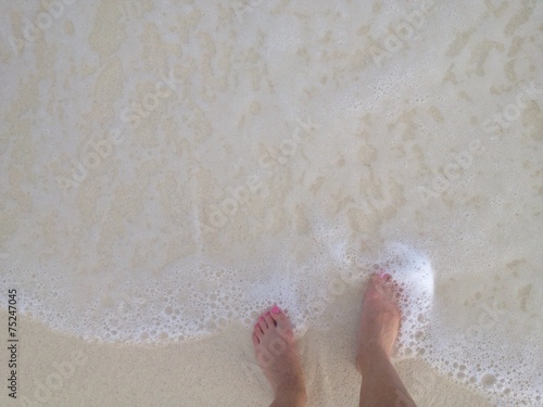 Stapping into the ocean, sandy beach photo