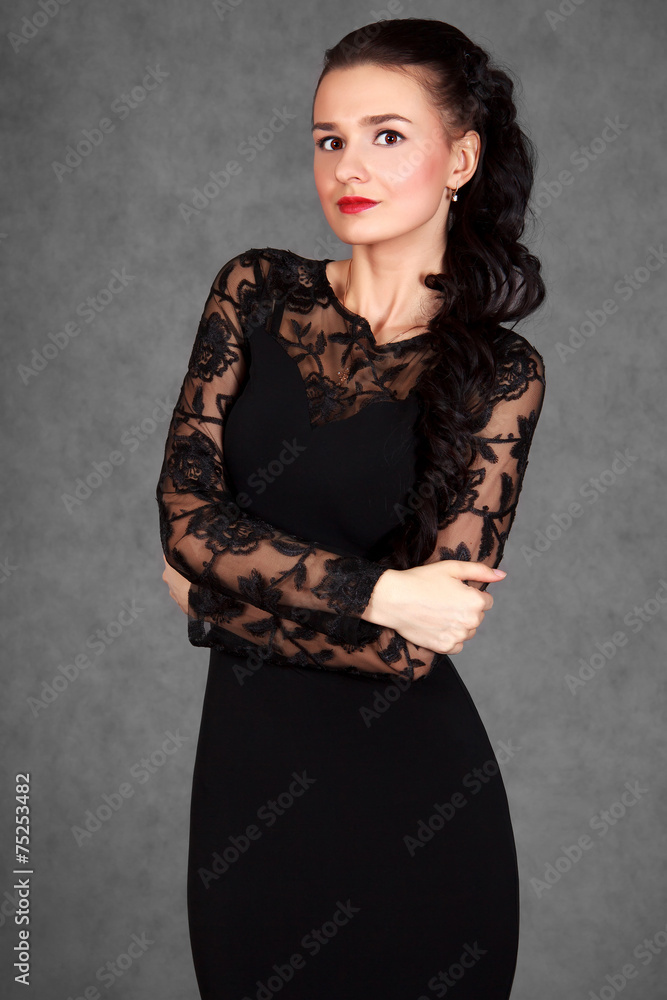 Portrait of a young attractive woman in a black evening dress Portrait of a young attractive woman in a black evening dress