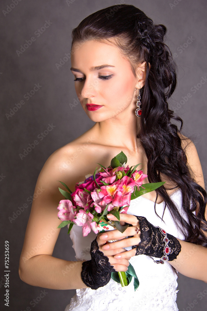 Portrait of a young beautiful fiancee with a bunch of pink flowe Portrait of a young beautiful fiancee with a bunch of pink flowe