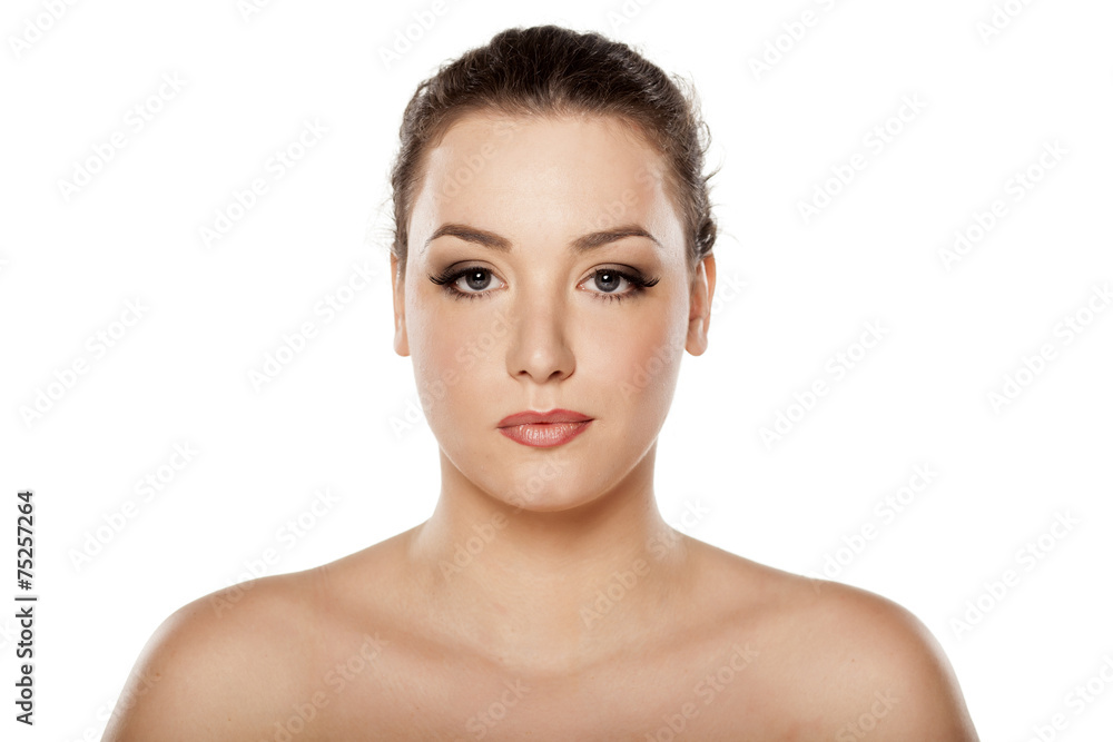 serious young woman on a white background serious young woman on a white background
