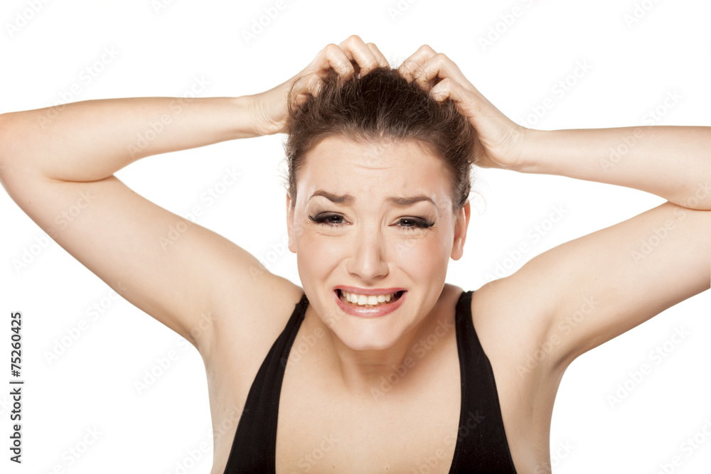unhappy young woman scratching her head