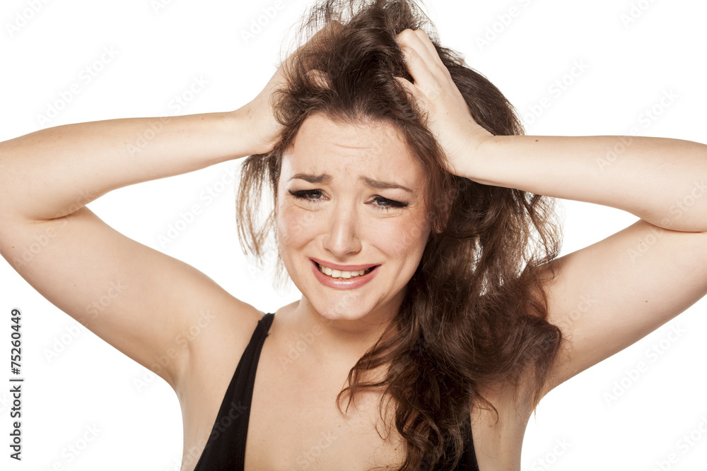unhappy young woman scratching her head