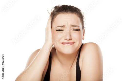 unhappy young woman has pain in the ear