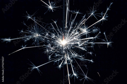 Celebrate party sparkler little fireworks on black background © kamilpetran