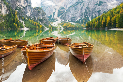 Closeup on boats on lake braies in south tyrol, italy photo
