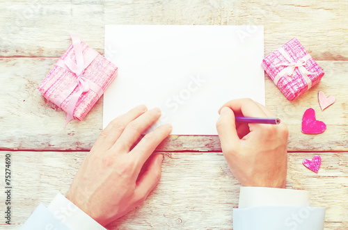 male hand writing a letter