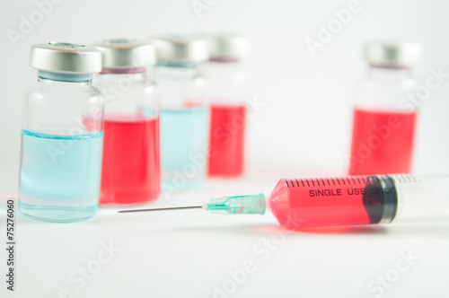 Red liquid in injection vials and syringe