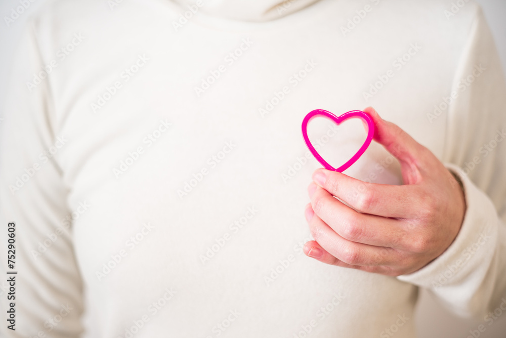 Pink heart on white sweater