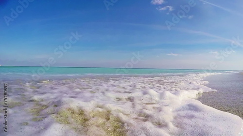Waves in slow motion flowing over the camera