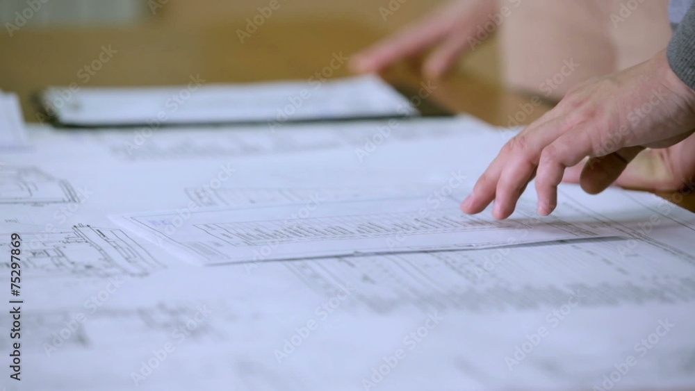 Review of documents and handshake closeup Review of documents and handshake closeup