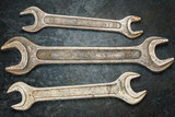 Vintage metallic spanners on the rusty metal surface