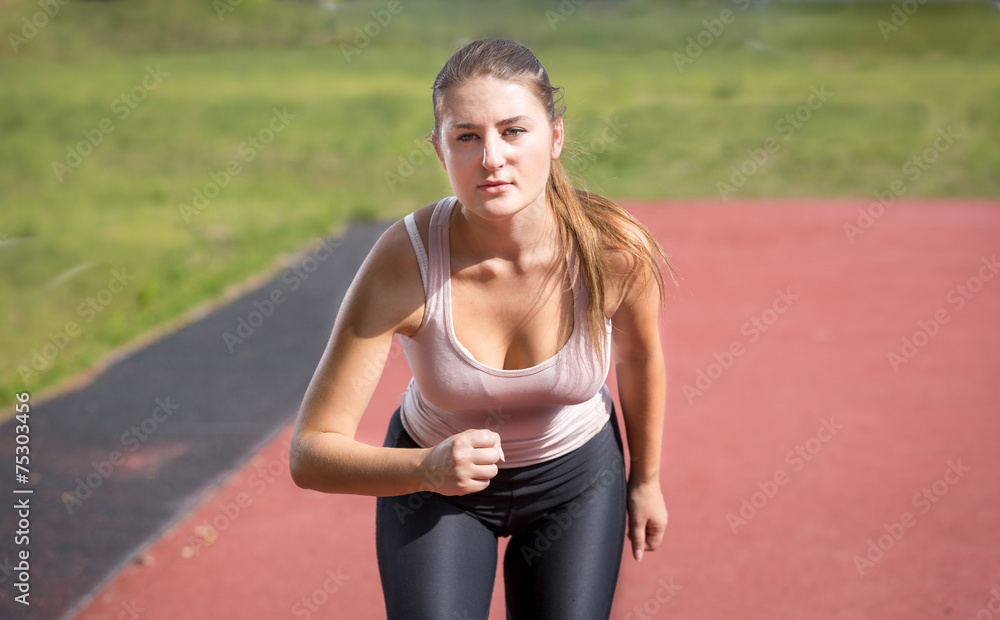 sexy slim woman running on stadium at sunny day sexy slim woman running on stadium at sunny day