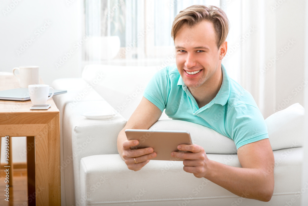 Man with gadget sitting at home Man with gadget sitting at home
