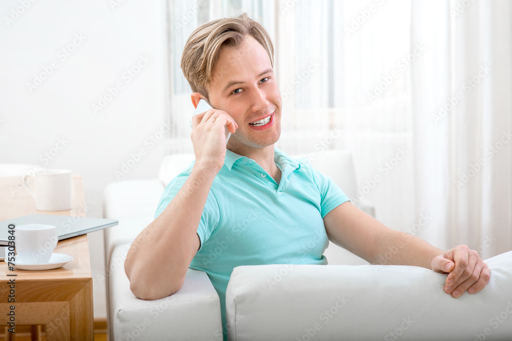 Man with gadget sitting at home