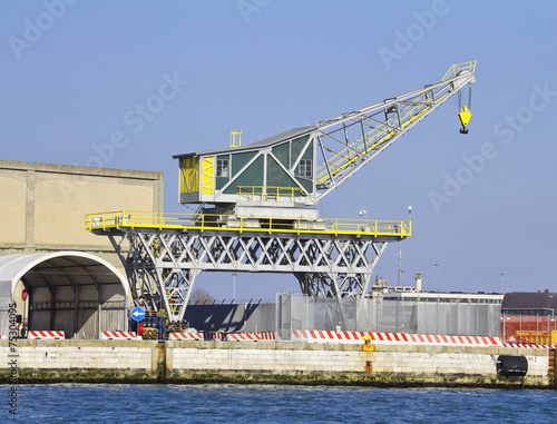 tall yellow industrial crane rising into sky