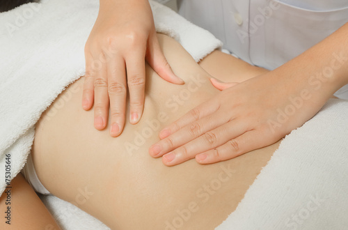 Woman having back massage in the spa