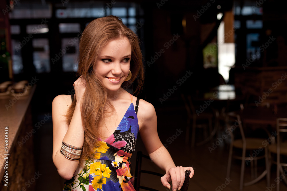 smiling beautiful young girl behind the counter at the bar smiling beautiful young girl behind the counter at the bar