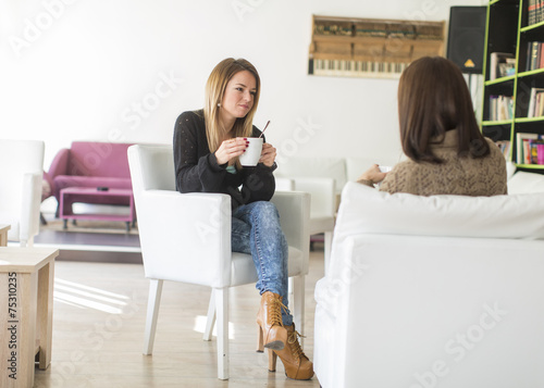 Young women talking and dri...