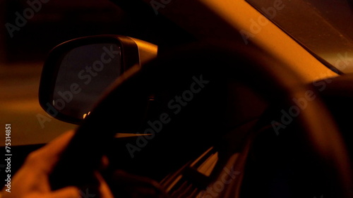 Person driving a car at night and having a trip