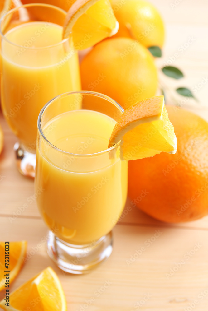 Freshly squeezed orange juice on wooden table Freshly squeezed orange juice on wooden table