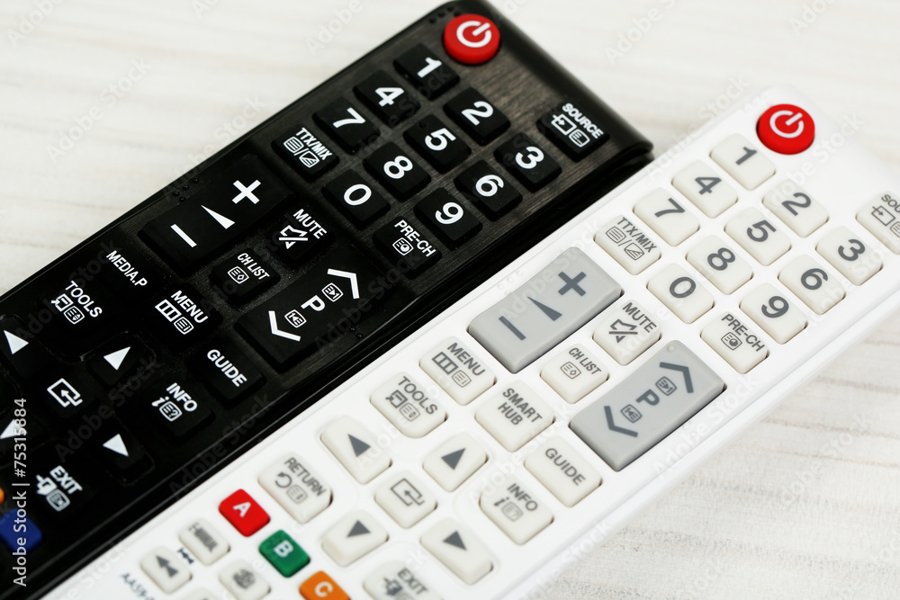 Two remote control devices on table Two remote control devices on table