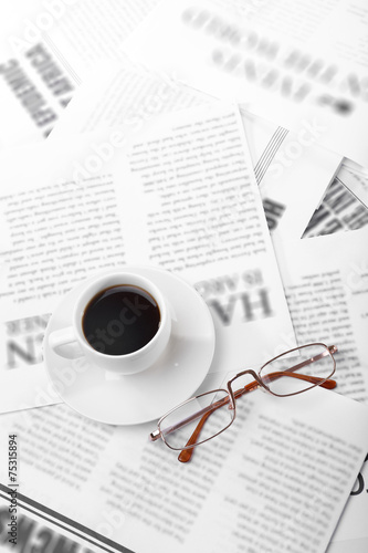 Glasses and newspapers, close-up