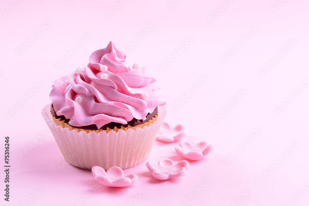 Delicious cupcake on pink background
