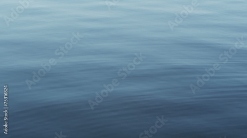 Calm surface of real water on a lake photo