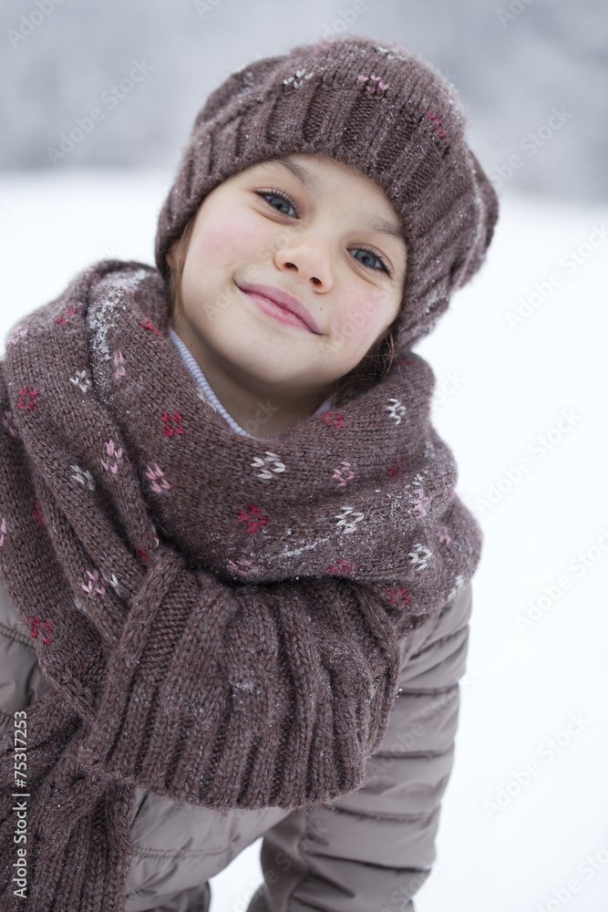 Happy little girl on the background of a winter park Happy little girl on the background of a winter park