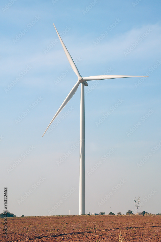 wind turbine against cloudy blue sky background wind turbine against cloudy blue sky background