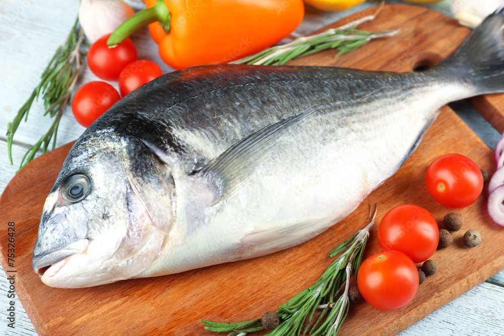 Fresh raw fish and food ingredients on table Fresh raw fish and food ingredients on table