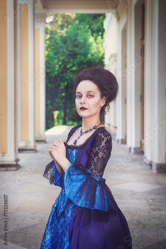 Beautiful young woman in blue medieval dress