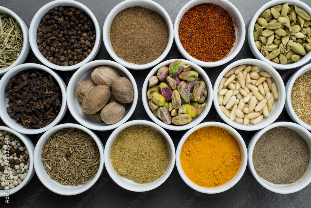 large collection of different spices and herbs isolated on Black