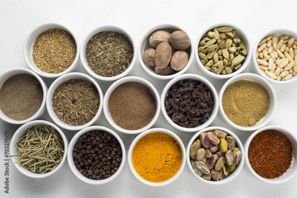 large collection of different spices and herbs isolated on white